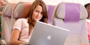 Image of woman on plane associated with article on inflight connectivity